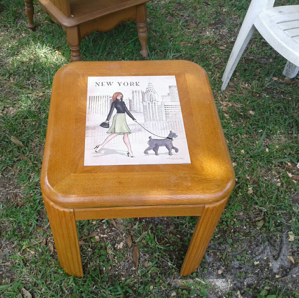 Side table topped with an Andrea Lalibert painting